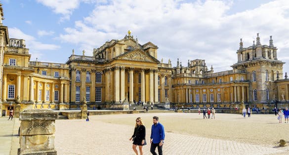 A view of Blenheim Palace and its front courtyard during a clear sky sunny day.