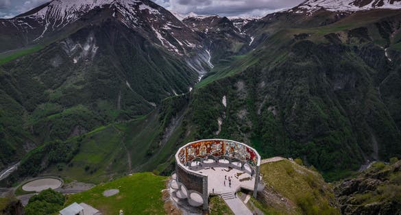 Photo of aerial view of friendship Monument on the Georgian military road at the Jvari pass, Georgia.