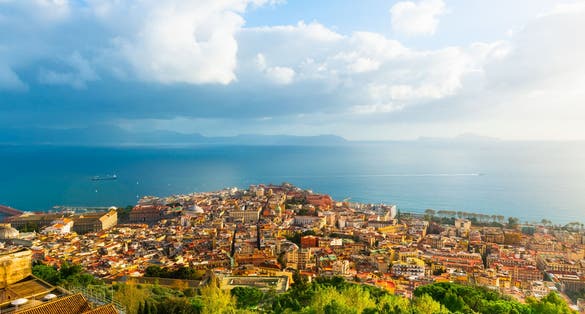 photo of view of Panoramic view of Naples city and Gulf of Naples, Italy. Blue sea and the sky with clouds at sunset. Famous travel destination.
