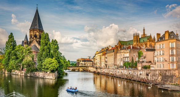 Photo of Metz city view of Petit Saulcy an Temple Neuf and Moselle River in Summer, France.