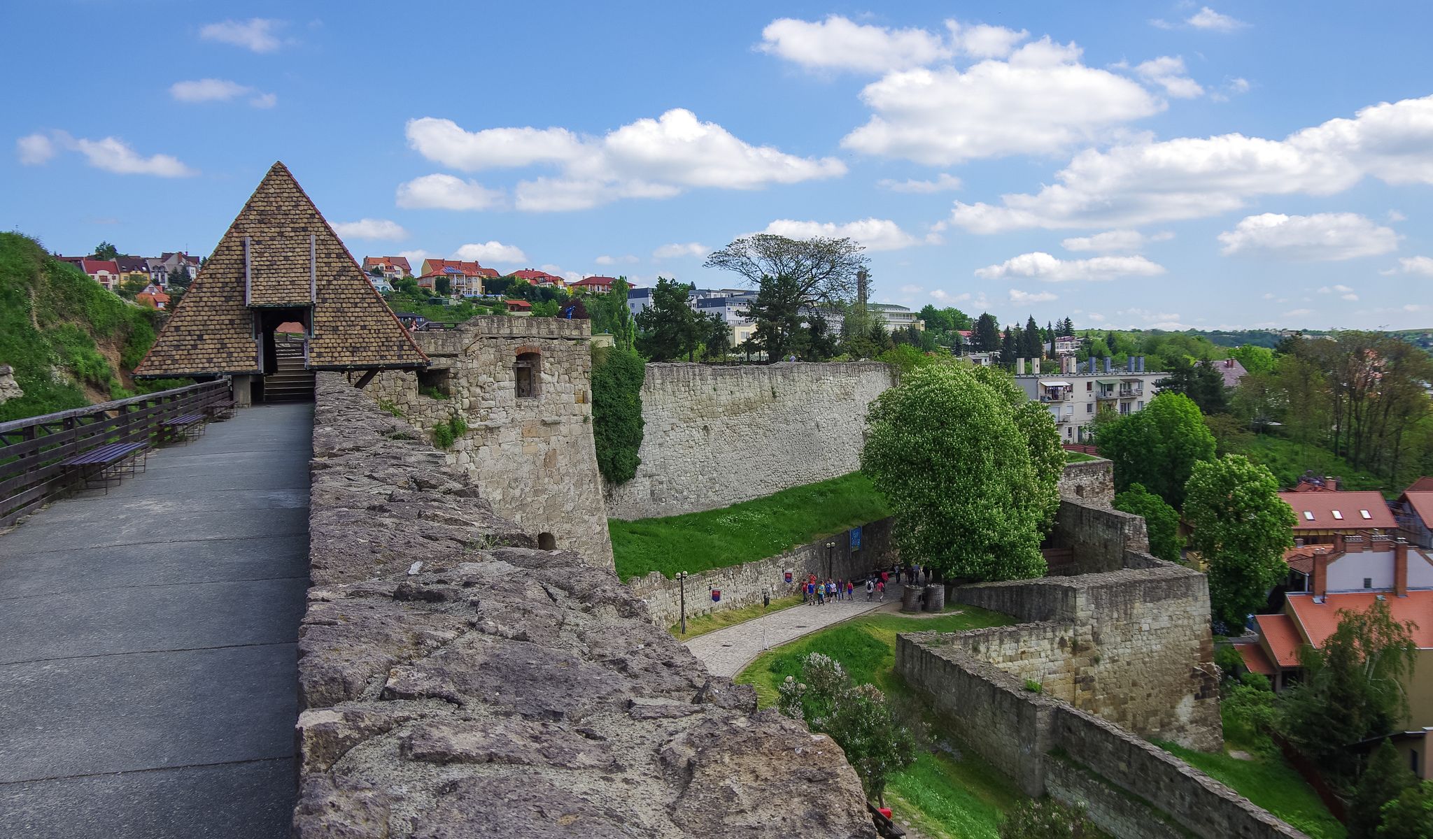 Photo of walls and main gate of rampart of the Eger fort (castle) with medieval town of Eger at background, Hungary