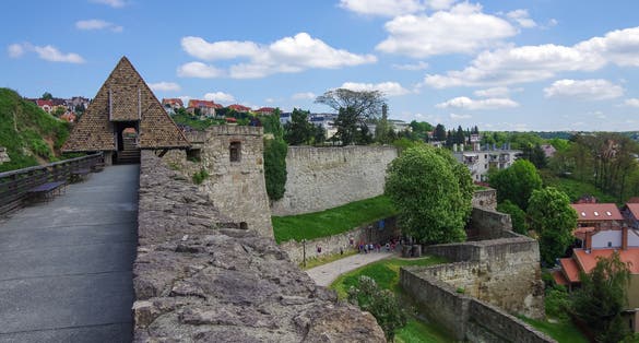 Photo of walls and main gate of rampart of the Eger fort (castle) with medieval town of Eger at background, Hungary