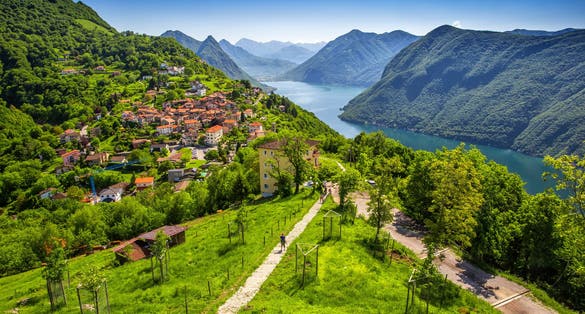 Photo of aerial view to Lugano city, Lugano lake and Monte San Salvatore from Monte Bre, Ticino, Switzerland.