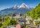 photo of historic town of Berchtesgaden with famous Watzmann mountain in the background on a sunny day with blue sky and clouds in springtime, National Park Berchtesgaden Land, Upper Bavaria, Germany.