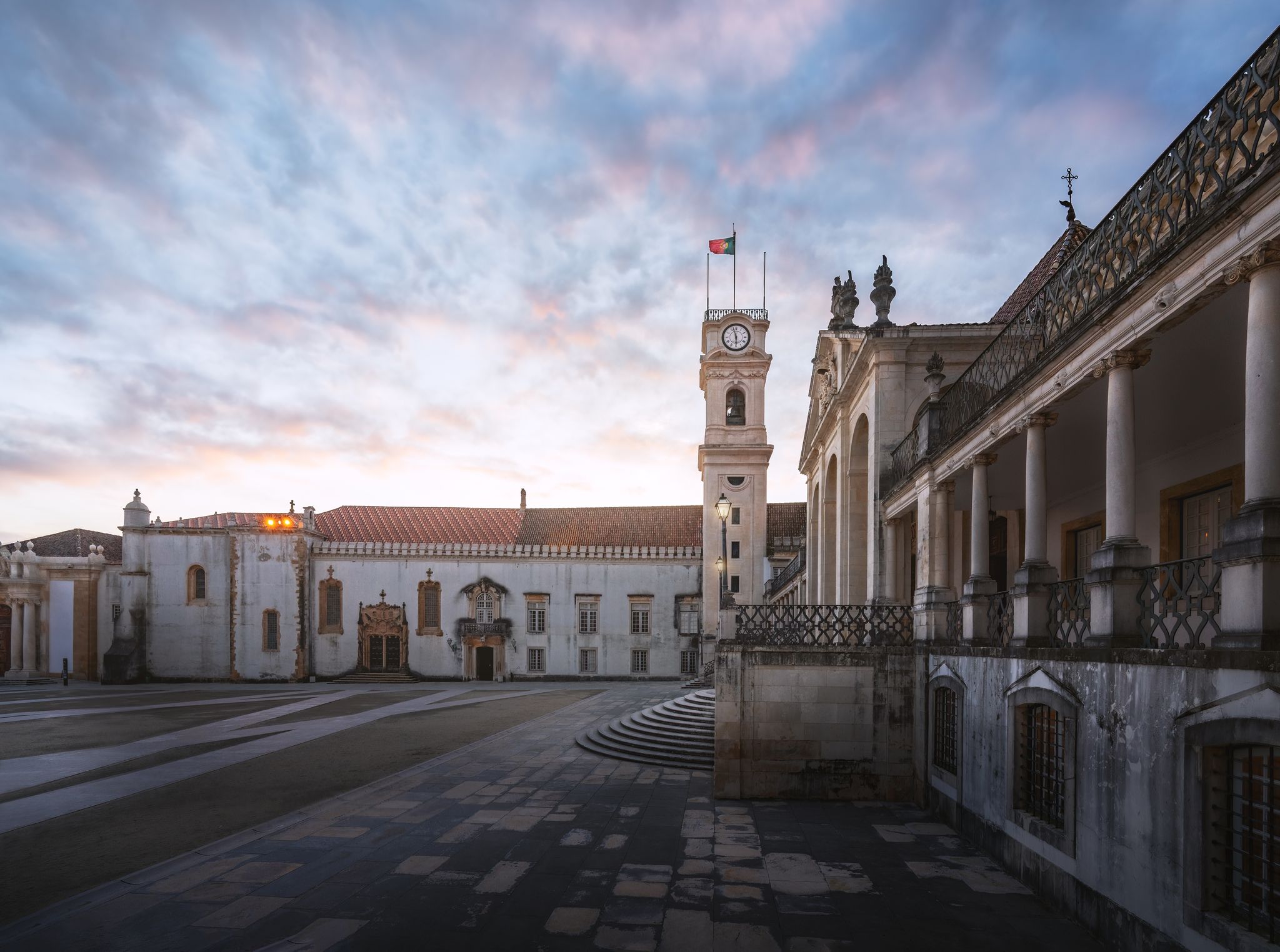 Photo of Clock Tower and University of Coimbra courtyard (Paco das Escolas) at sunset, former Royal Palace - Coimbra, Portugal.