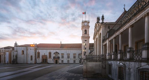 Photo of Clock Tower and University of Coimbra courtyard (Paco das Escolas) at sunset, former Royal Palace - Coimbra, Portugal.