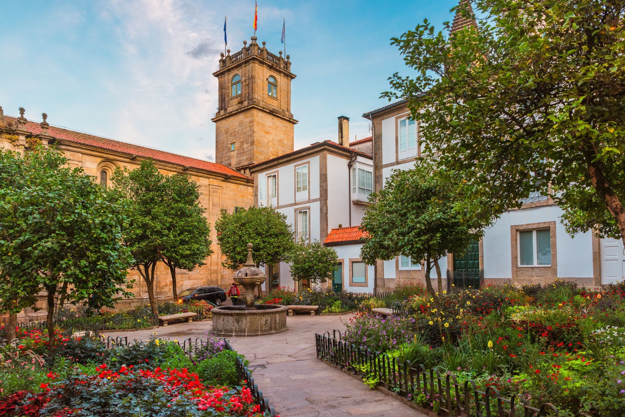 photo of  view of Small square in Santiago de Compostela city with flower garden and fountain, Galicia, Spain. Popular touristic landmark