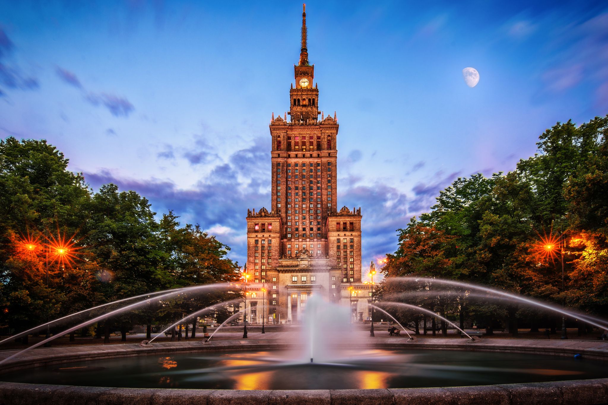 Photo of Palace of Culture and sciences at night one of the main travel attractions ,the Main symbol of Warsaw with Fountain Close Up, Warsaw, Poland.