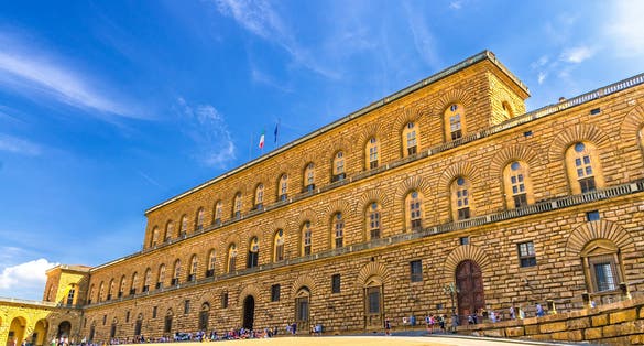 Facade of Palazzo Pitti palace with Gallery of Modern Art large building on Piazza dei Pitti square in historical centre of Florence city, blue sky white clouds, Tuscany, Italy