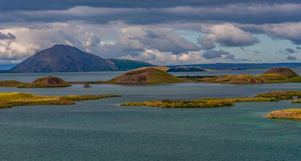 photo of view of Lake Mývatn is a lake in the northeast of Iceland. There is blue-hued water, which is characterised by high clarity, Reykjahlíð, Iceland.