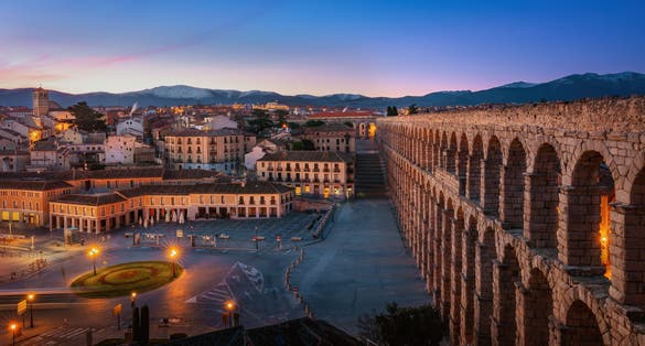 photo of view of Aqueduct of Segovia and Plaza Oriental Square at sunset - Segovia, Spain.