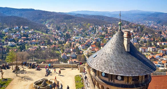 View of the courtyard with tower at Wernigerode Castle with the Harz Mountains and the city in the background. Germany