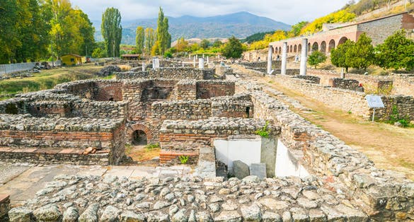 Photo of Historical site with ruins of Heraclea city with no people surounded by mountains nature in Bitola. Macedonia sightseeing historical objects .