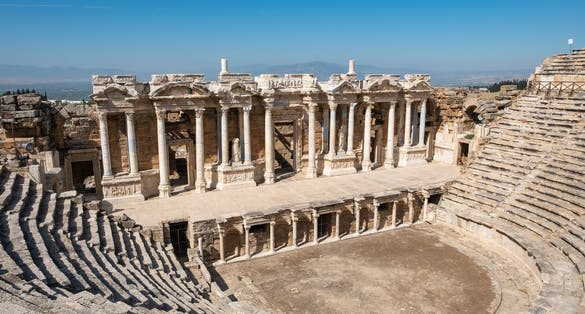 Photo of ruins of a large amphitheater in the ancient city of Hierapolis near Pamukkale, Denizli, Turkey. 