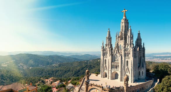 Photo of Temple Sacred Heart of Jesus on Mount Tibidabo on background of blue sky, Barcelona, ​​Spain.