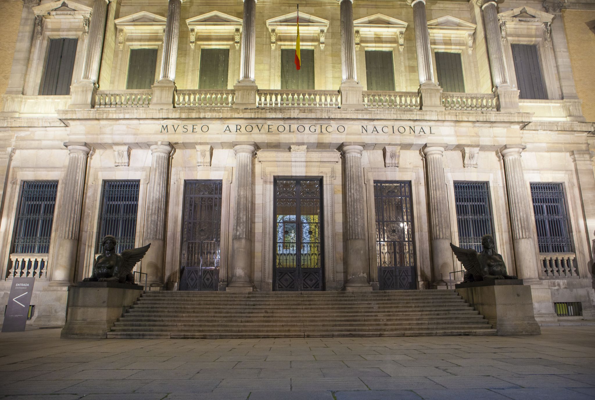 photo of facade building at night of National Archaeological Museum in Madrid, Spain.