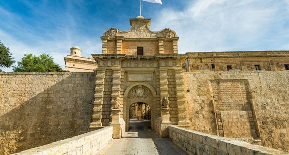 Photo of entrance bridge and gate to Mdina, a fortified medieval city in the Northern Region of Malta.