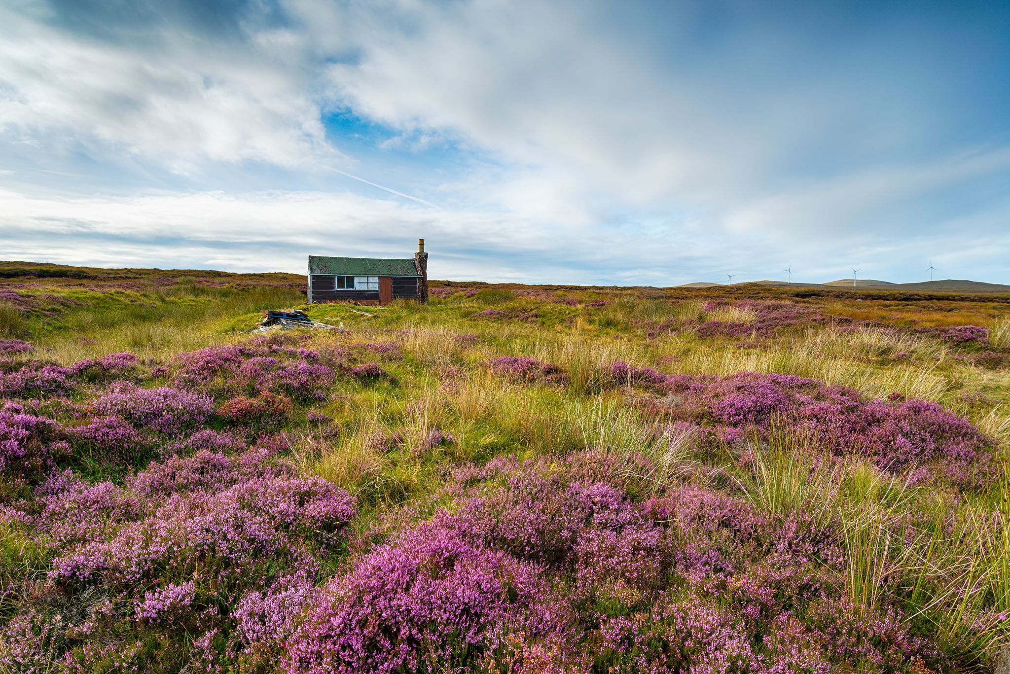 photo of a Scottish shieling hut on peat bog near Stornoway on the Isle of Lewis in the Outer Hebrides.