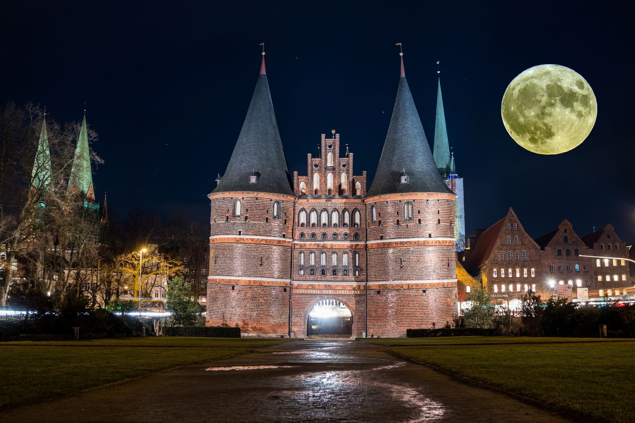 Holstentor in Luebeck with moon in the sky