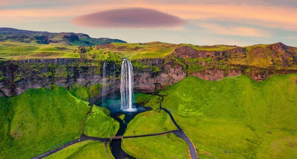 photo of breathtaking morning view from flying drone of Seljalandsfoss waterfall. Fantastic summer sunrise in Iceland, Europe. Beauty of nature concept background.