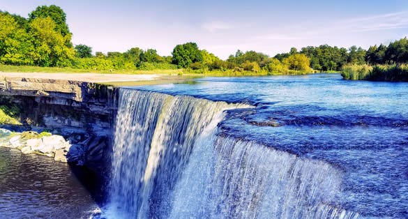 Photo of crystal clear blue waters of Jagala waterfall, Estonia.