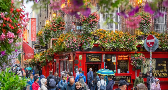 People walking by famous Irish pub, THE TEMPLE BAR, Dublin, Ireland.