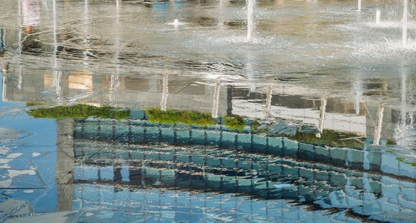 PHOTO OF Reflection from fountain water in Gae Aulenti square, Milan, Lombardy, Italy.