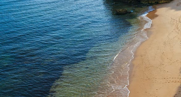 Beach Praia dos Beijinhos summer evening view. Atlantic coast landscape (Lagoa, Algarve, Portugal).