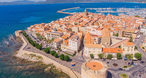 Aerophotography. View from flying drone.Panoramic cityscape of old town of Alghero (L’Alguer), Province of Sassari, Italy, Europe. Spectacular scene of Sardinia island, Mediterranean seascape.Top View