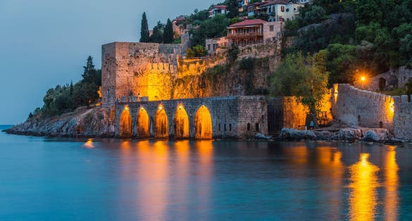 View of ancient shipyard near of Kizil Kule tower in Alanya peninsula, Antalya district, Turkey, Asia. Famous tourist destination with high mountains. Part of ancient old Castle.