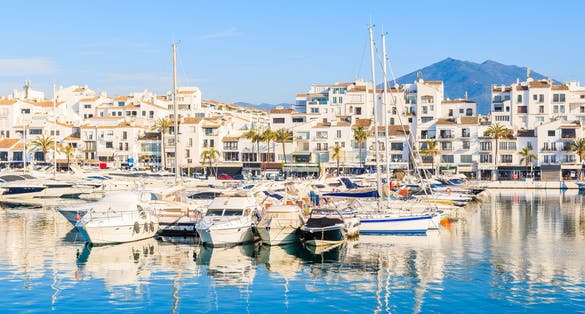 Photo of View of Puerto Banus marina with boats and white houses in Marbella town at sunrise, Andalusia, Spain.