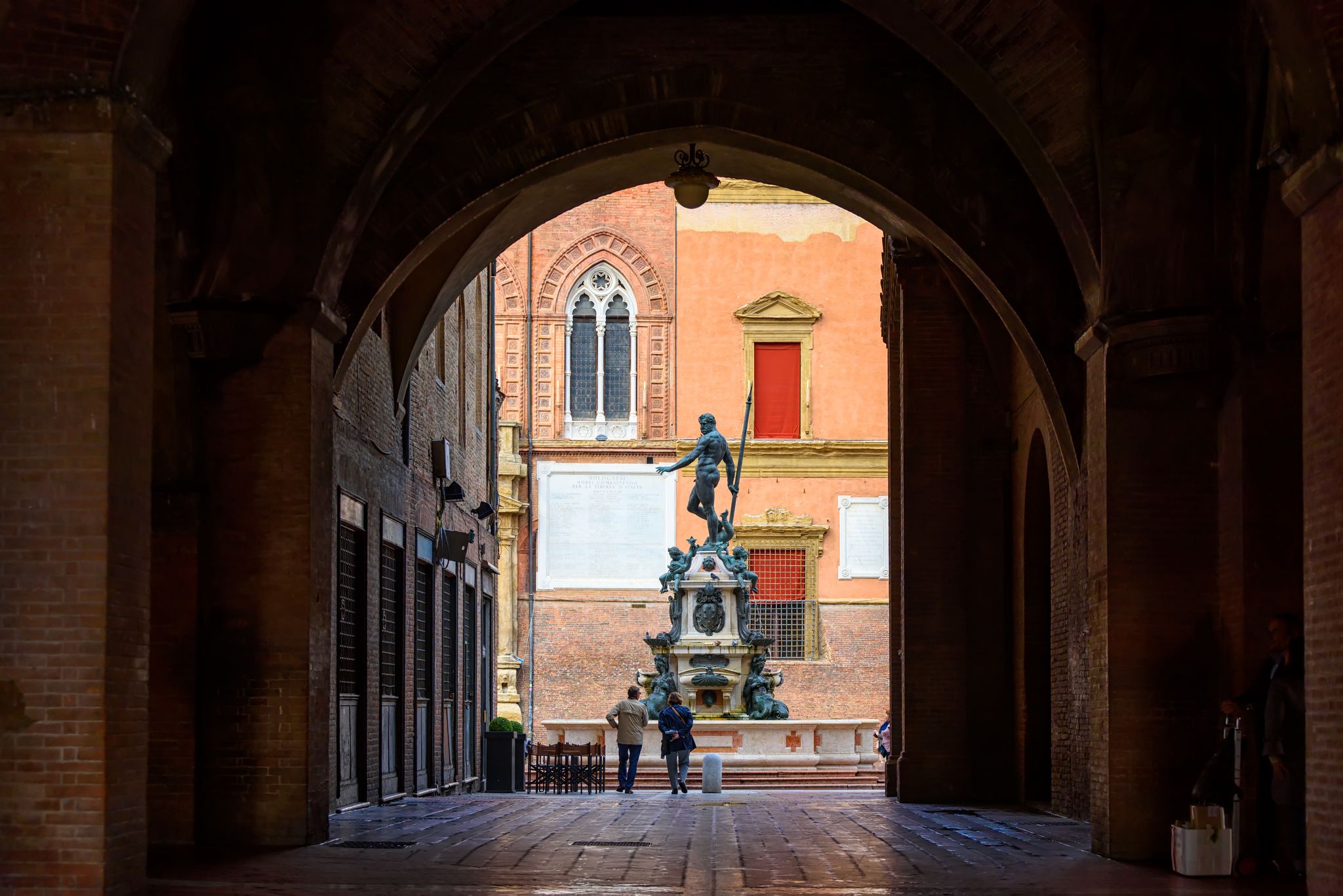 photo of The Fountain of Neptune (Fontana di Nettuno) located in Piazza del Nettuno in Bologna, Italy. Architecture and landmark of Bologna. Cityscape of Bologna.