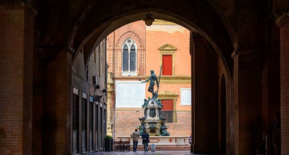 photo of The Fountain of Neptune (Fontana di Nettuno) located in Piazza del Nettuno in Bologna, Italy. Architecture and landmark of Bologna. Cityscape of Bologna.