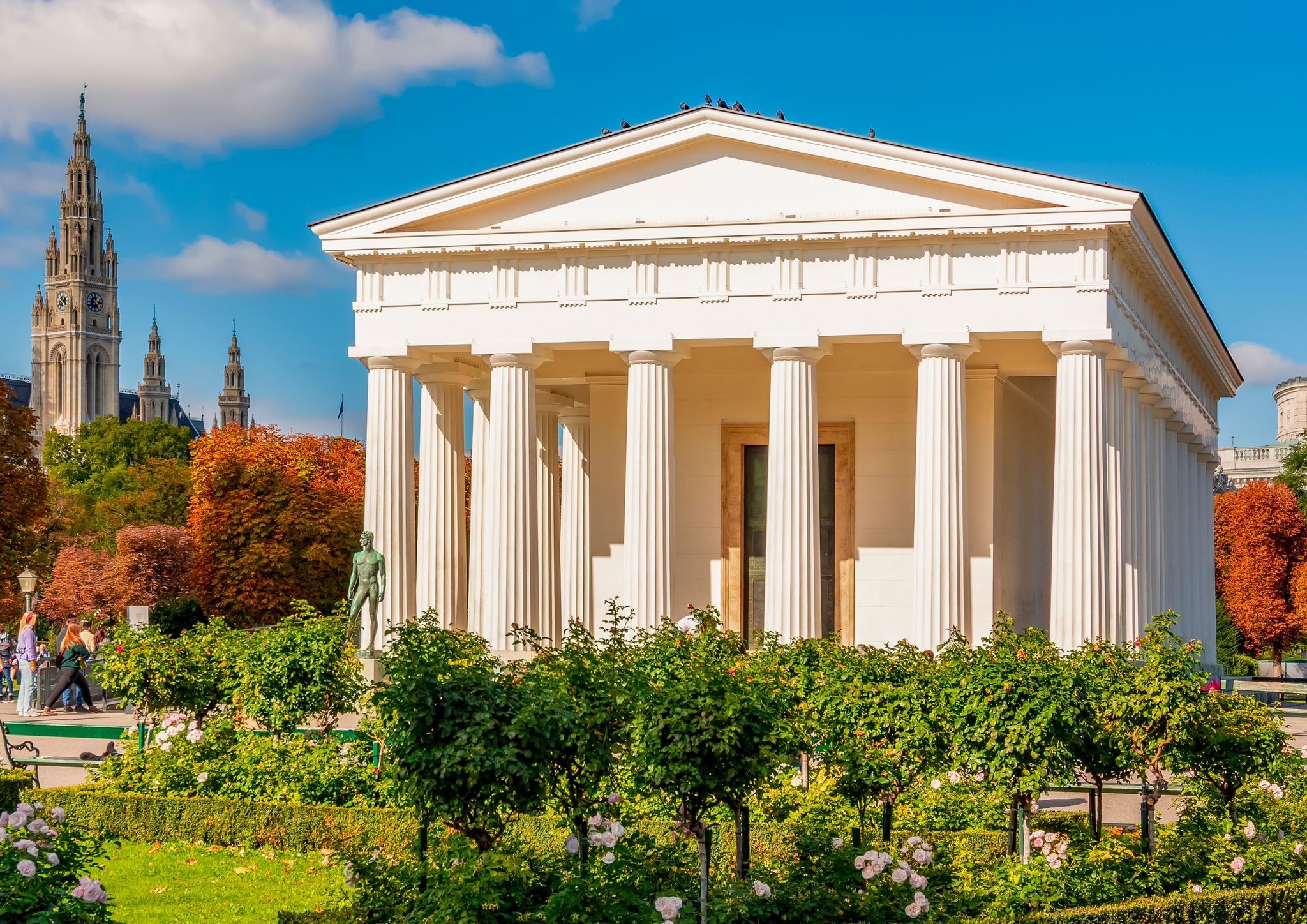 Photo of temple of Theseus in Volksgarten park with City Hall at background, Vienna, Austria.