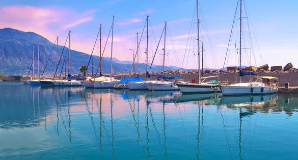 Photo of sunset boats reflection at Kalamata harbor.