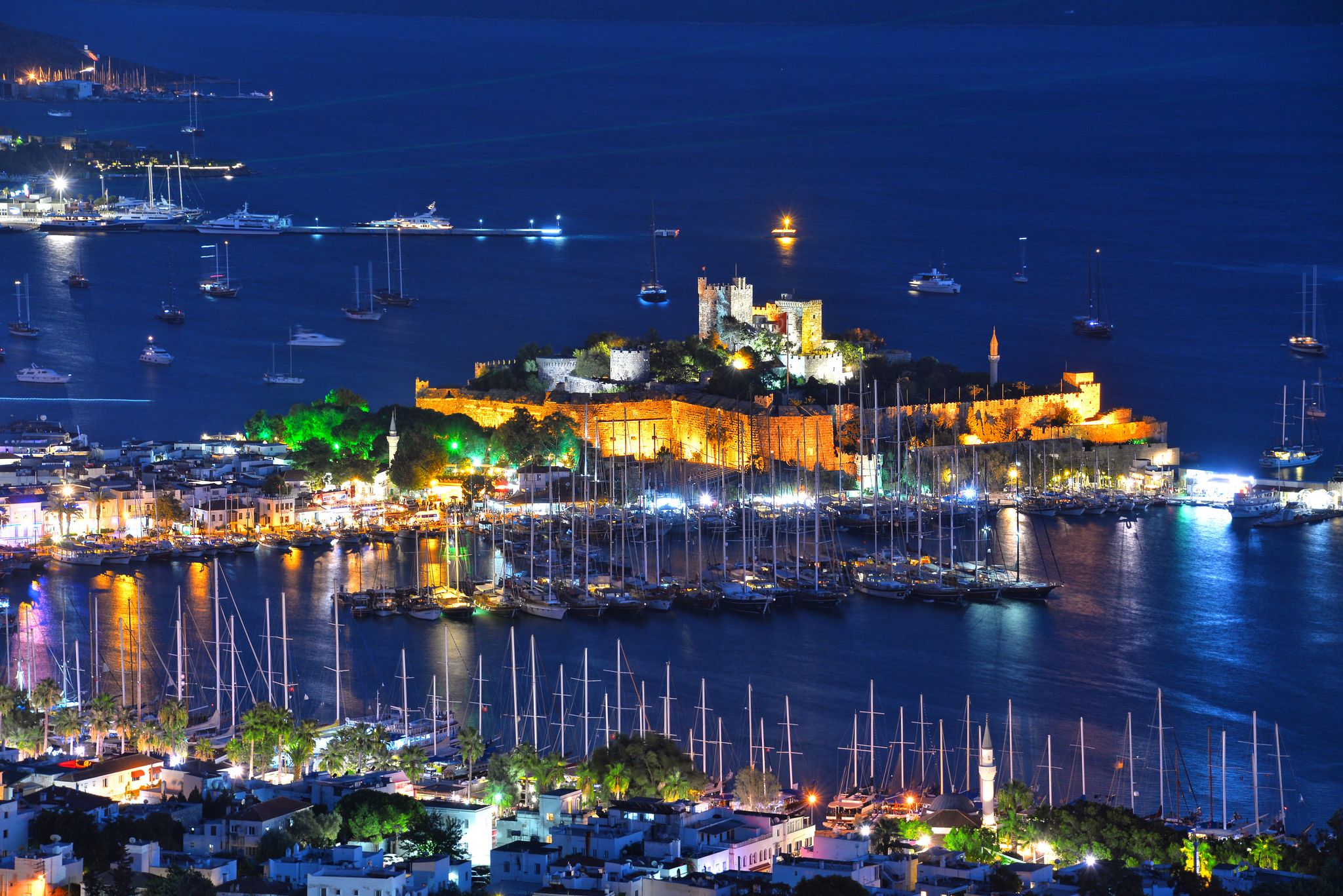 photo of Bodrum harbor and Castle of St. Peter (Bodrum Castle) by night in Bodrum, Turkey.