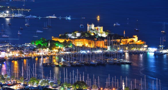 photo of Bodrum harbor and Castle of St. Peter (Bodrum Castle) by night in Bodrum, Turkey.