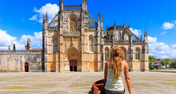 Woman tourist in front of The Monastery of Batalha- Portugal, Leiria