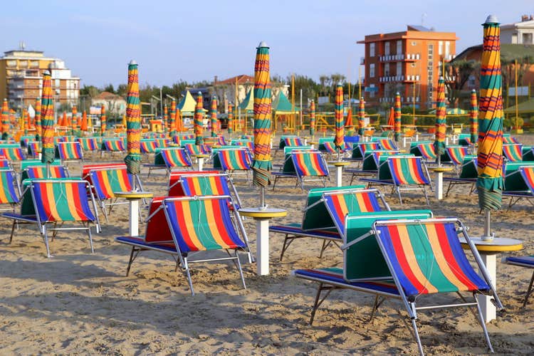 Photo of empty beach with a lot of sunbeds and umbrellas in Viserba, Rimini, Italy.