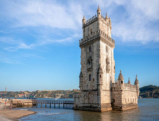 Belem Tower in Lisbon under a clear summer sky, a top attraction to explore in Portugal in August..jpg