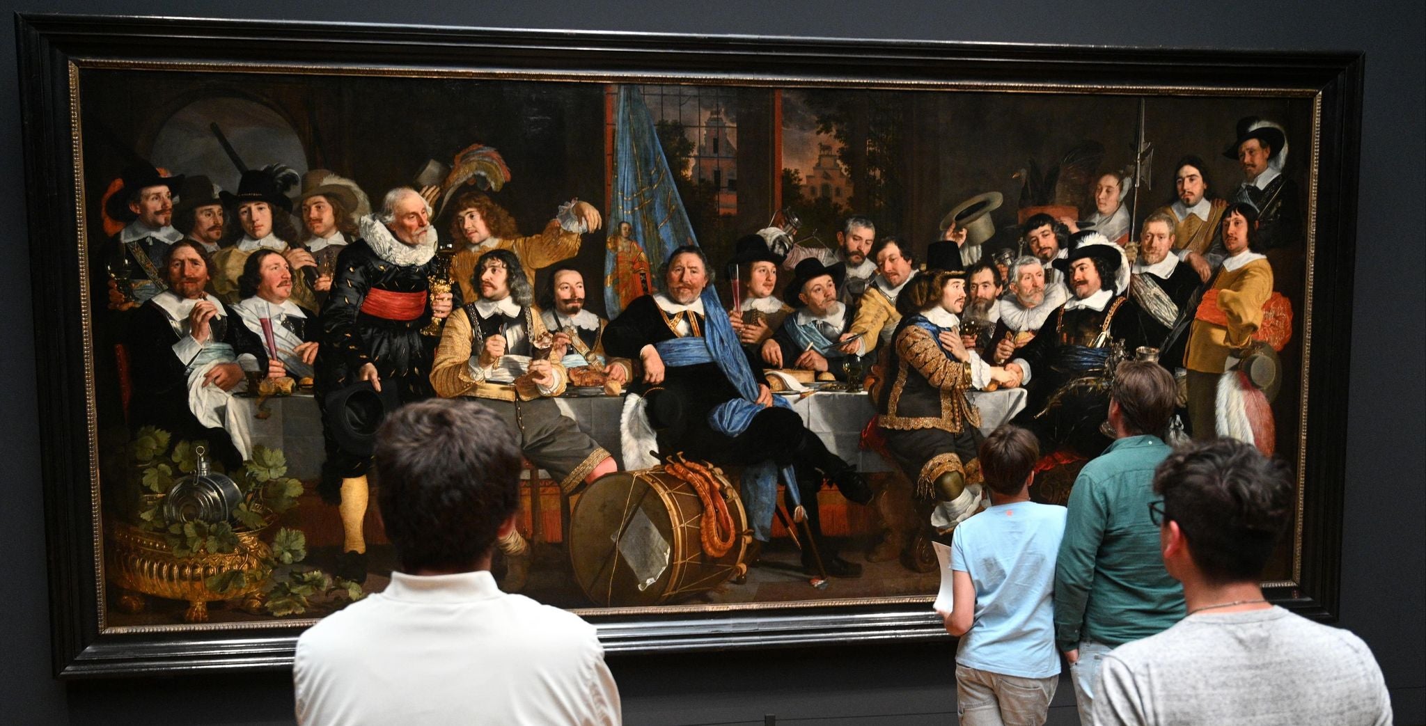 Visitors viewing a large Dutch Golden Age painting at the Rijksmuseum in Amsterdam..jpg