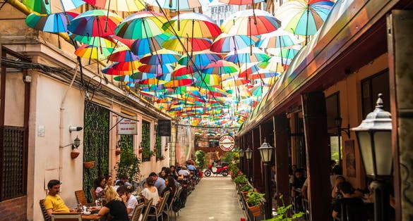 Cafe with colorful umbrellas on a street in Bucharest.