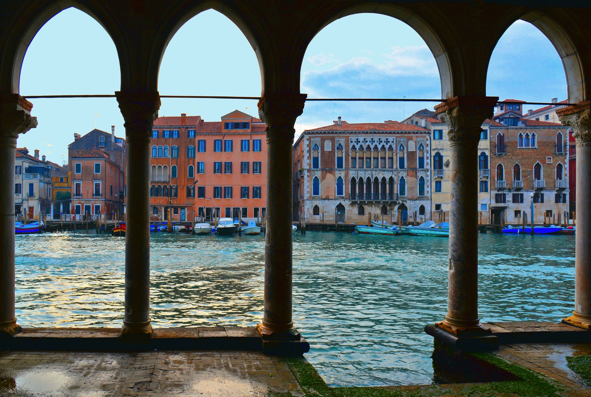 photo of The water Canal Grande and old buildings and architecture view from the balcony of the Ca' d'Oro, a gothic palace in Venice, Italy.