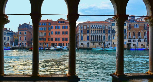 photo of The water Canal Grande and old buildings and architecture view from the balcony of the Ca' d'Oro, a gothic palace in Venice, Italy.