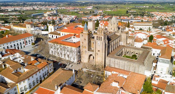 Evora drone aerial view on a sunny day with historic buildings city center and church in Evora Alentejo, Portugal