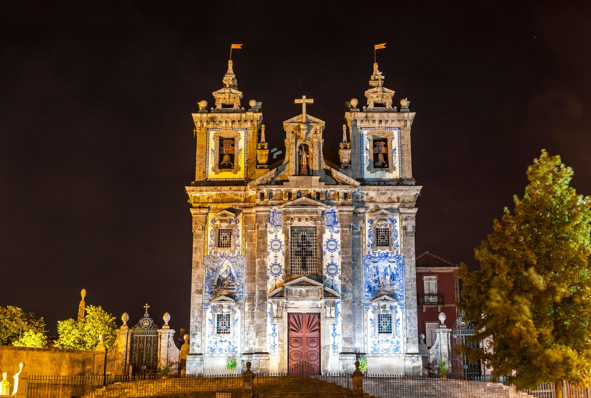 Photo of Night view of facade of Church of Saint Ildefonso (Igreja Paroquial de Santo Ildefonso) in old center of Porto city, Portugal. church was completed in 1739 in a proto-Baroque style.