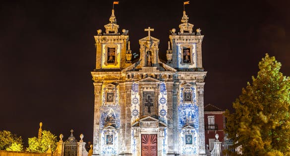 Photo of Night view of facade of Church of Saint Ildefonso (Igreja Paroquial de Santo Ildefonso) in old center of Porto city, Portugal. church was completed in 1739 in a proto-Baroque style.