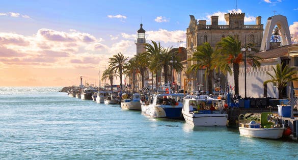Photo of lighthouse and old fishing port of Grau du Roi in Camargue zoological nature reserve, Montpellier, South of France.