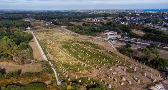 photo of aerial view of the Carnac stone alignments of Ménec in Morbihan, France.