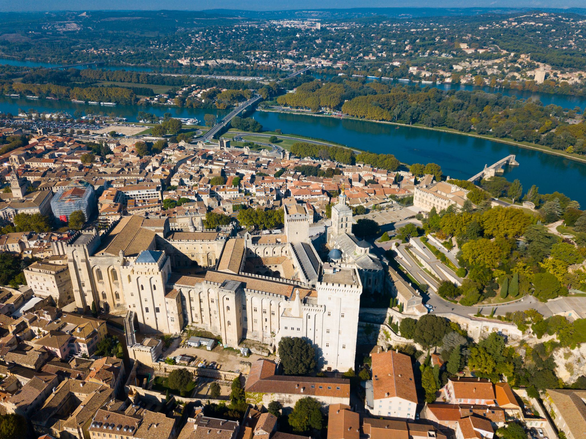 photo of an aerial view of Avignon on bank of Rhone River with Palais des Papes in sunny autumn day, France.